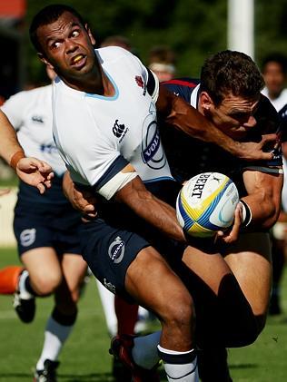 Kurtley Beale offloads as he's tackled.