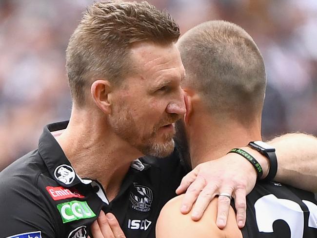 MELBOURNE, AUSTRALIA - SEPTEMBER 29: Magpies head coach Nathan Buckley hugs Steele Sidebottom  during the 2018 AFL Grand Final match between the Collingwood Magpies and the West Coast Eagles at Melbourne Cricket Ground on September 29, 2018 in Melbourne, Australia.  (Photo by Quinn Rooney/Getty Images)