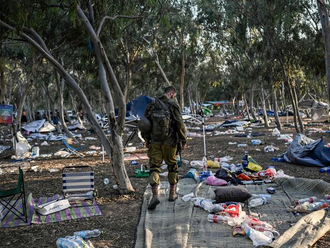 EDITORS NOTE: Graphic content / TOPSHOT - -- AFP PICTURES OF THE YEAR 2023 --  An Israeli soldier patrols near Kibbutz Beeri in southern Israel on October 12, 2023, close to the place where 270 revellers were killed by militants during the Supernova music festival on October 7.. Thousands of people, both Israeli and Palestinians have died since October 7, 2023, after Palestinian Hamas militants entered Israel in a surprise attack leading Israel to declare war on Hamas in the Gaza Strip enclave the following day. (Photo by Aris MESSINIS / AFP) / AFP PICTURES OF THE YEAR 2023