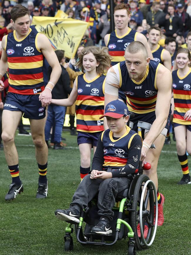 Hugh Greenwood pushes a Crows mascot on to Adelaide Oval. Picture Sarah Reed