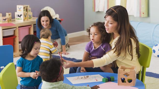 Teachers and toddlers in daycare.Preschool, Nursery School Building, Child, Child Care, Education, Teacher, Toddler, Learning, Messing About, Playing, Teaching, Childhood, Boys, Assistance, Latin American and Hispanic, Table, Toy, Group Of People,  Fun, Multiracial Group, Friendship, Girls, People, Adult, Indoors, Occupation, 18-23 Months, 25-29 Years, 30-39 Years, African-American Ethnicity, Asian, Blonde Hair, Brown Hair, Caucasian Appearance, Cheerful, Colour Image, Colouring, Crayon, Cute, Daycare, Filipino, Growth, Horizontal, Large Group Of People, Latin, Thinkstock, Generic, Childcare