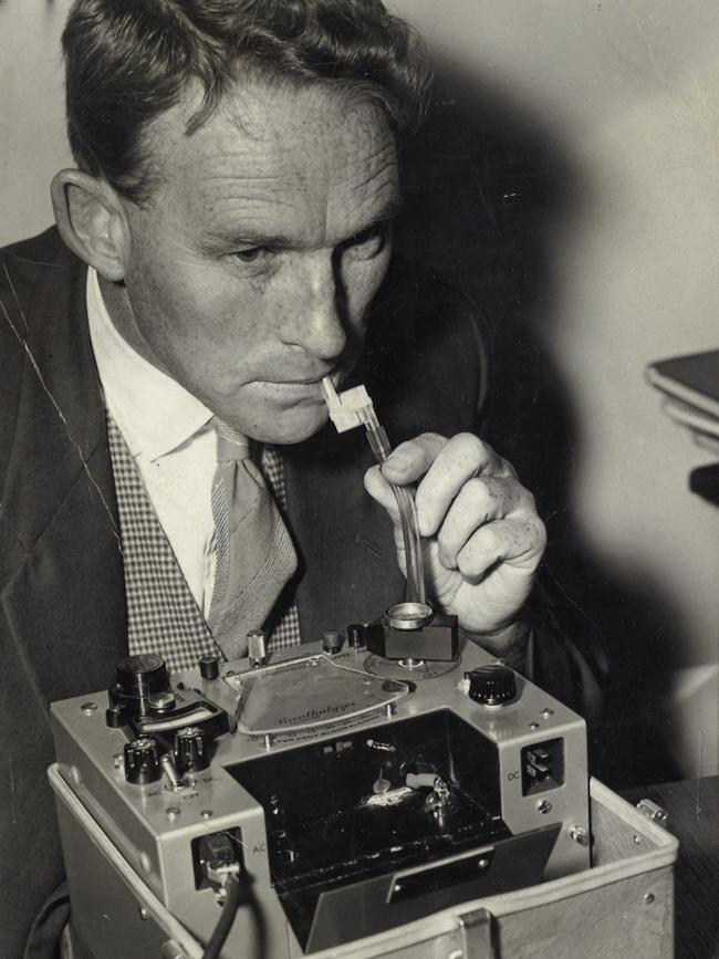 1961: A reporter tries out an early breathalyser at the Russell St police headquarters in Melbourne. Victoria made it an offence to drive a car with a blood-alcohol level greater than .05 per cent in 1966.