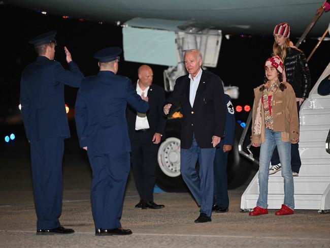 US President Joe Biden, followed by granddaughter Natalie and her friend, steps off Air Force One upon arrival at Joint Base Andrews in Maryland on January 2, 2024. The President and First Lady are returning to Washington after spending the New Year holiday in Saint Croix. (Photo by Mandel NGAN / AFP)