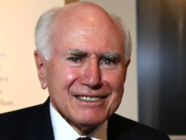 Former Prime Minister John Howard with the desk both Robert Menzies and John Howard used while serving as Prime Minister. At the official opening the Menzies: By John Howard exhibition at the Museum of Australian Democracy in Old Parliament House, Canberra. Pic by Kym Smith