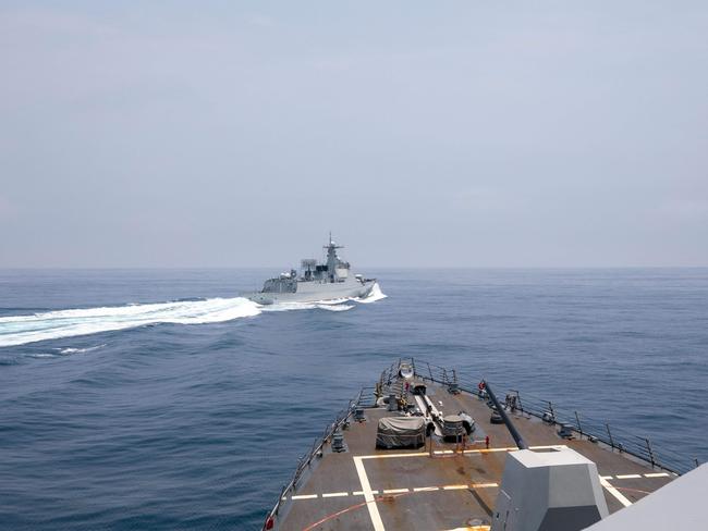 This handout photo taken on June 3, 2023 by the US Navy shows the Arleigh Burke-class guided-missile destroyer USS Chung-Hoon observing the Chinese PLA Navy vessel Luyang III (top) while on a transit through the Taiwan Strait.