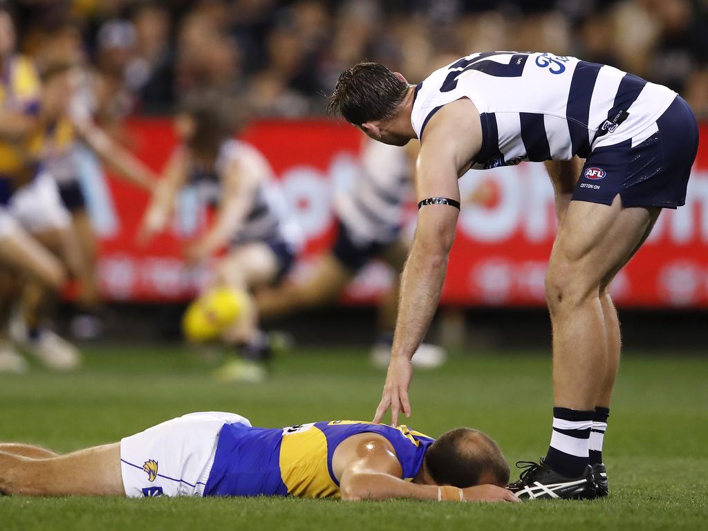 Tom Hawkins checks on Will Schofield after striking him. Picture: Getty Images