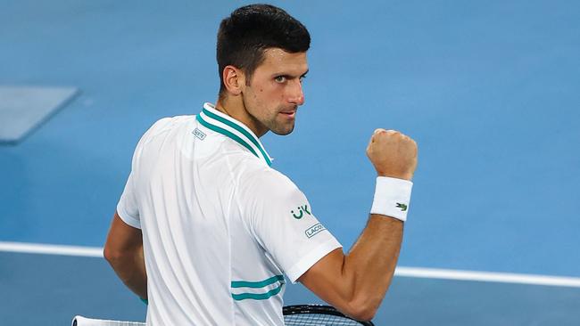 Serbia's Novak Djokovic celebrates beating Russia's Aslan Karatsev in their men's singles semi-final match on day eleven of the Australian Open tennis tournament in Melbourne on February 18, 2021. (Photo by Brandon MALONE / AFP) / — IMAGE RESTRICTED TO EDITORIAL USE – STRICTLY NO COMMERCIAL USE —