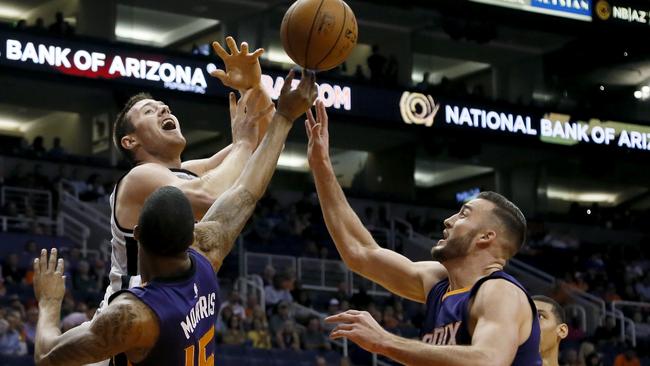San Antonio Spurs forward Aron Baynes, top left, loses the ball as Phoenix Suns center Miles Plumlee, front right, and Markieff Morris (15) defend during the first half of an NBA preseason basketball game, Thursday, Oct. 16, 2014, in Phoenix. (AP Photo/Matt York)