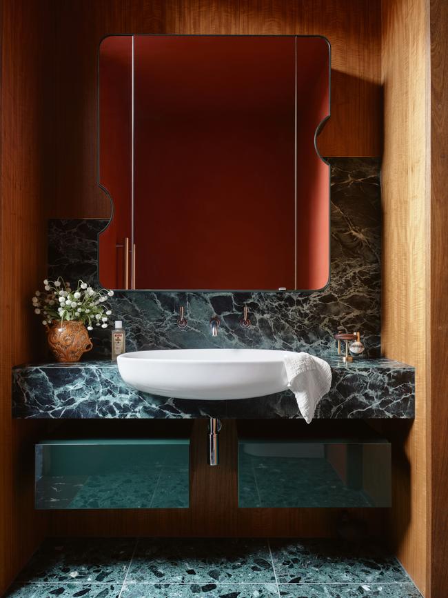 Using pieces including a vintage Italian vase, beautiful bath products and a vintage shave set in a smart modern bathroom lends a sense of European elegance.