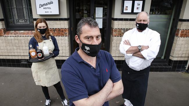 Paul Dimattina, with his business partner Geoff Lindsay and staff member Lily Duttine, at Lamaro’s restaurant, has launched a campaign to get businesses open again. Picture: David Caird