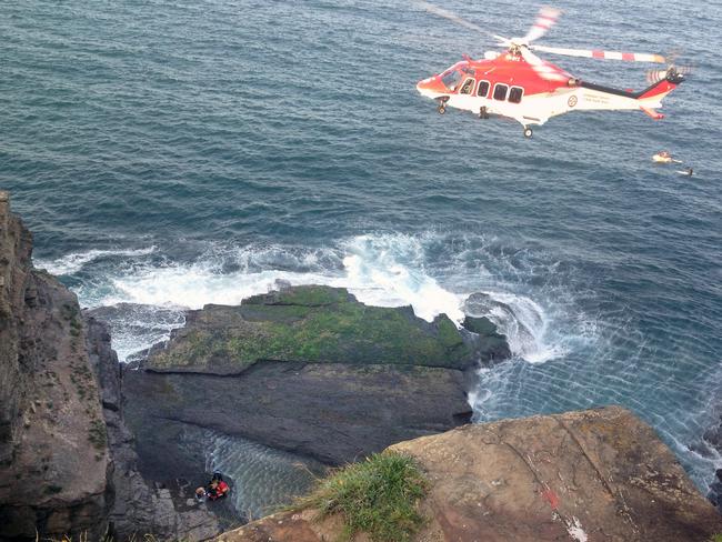 A rescue helicopter arrives at Warriewood blowhole on Turimetta headland yesterday.