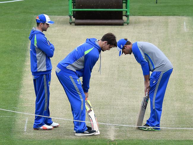 Callum Ferguson, Mitchell Marsh and Joe Burns inspect the pitch.