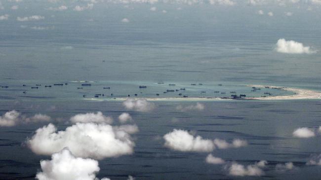 A photo taken through the window of a military plane shows China's alleged on-going reclamation of Mischief Reef in the Spratly Islands in the South China Sea.