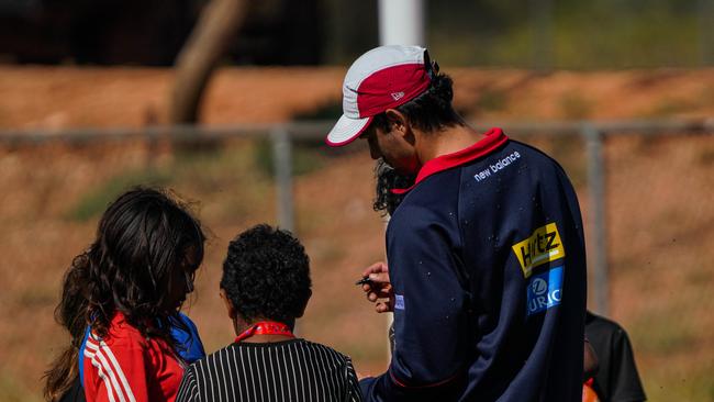 Melbourne Demons players Shane McAdam and Andy Moniz-Wakefield went to Santa Teresa ahead of the 2025 AFL game in Alice Springs. Picture: Melbourne Demons