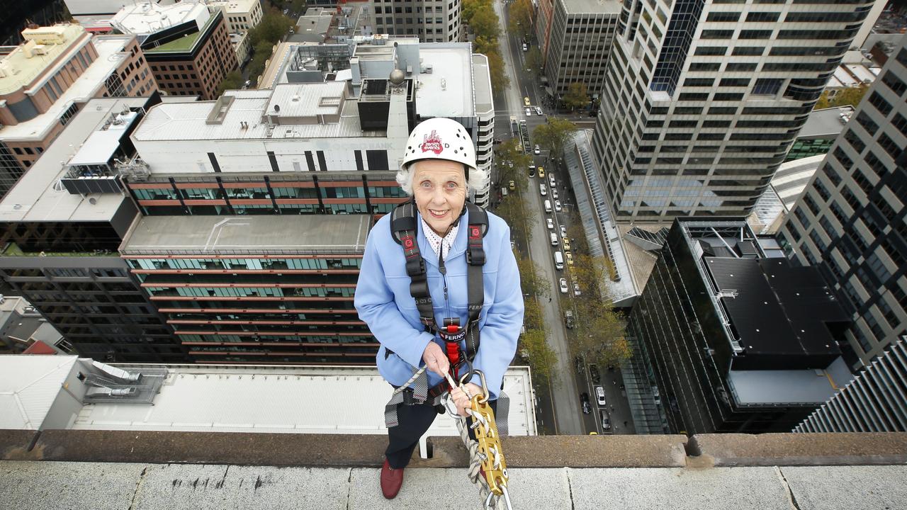 Jean Young abseiling 27 storeys down a Bourke St building in 2016. Picture: David Caird.