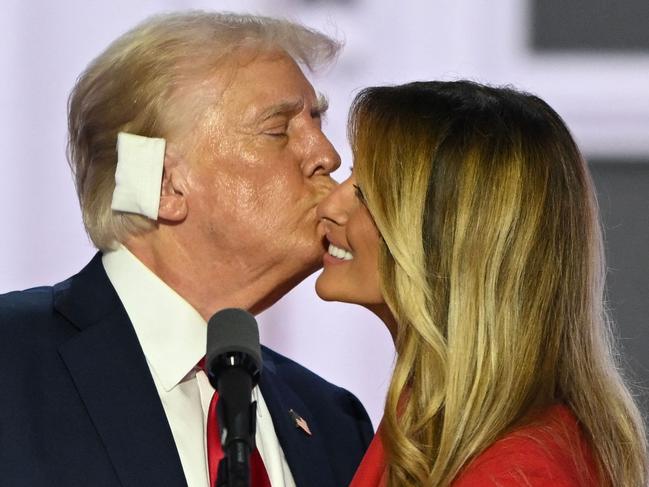 Former US President and 2024 Republican presidential candidate Donald Trump kisses former US First Lady Melania Trump onstage after he accepted his party's nomination on the last day of the 2024 Republican National Convention at the Fiserv Forum in Milwaukee, Wisconsin, on July 18, 2024. Days after he survived an assassination attempt Trump won formal nomination as the Republican presidential candidate and picked Ohio US Senator J.D. Vance for running mate. (Photo by ANDREW CABALLERO-REYNOLDS / AFP)