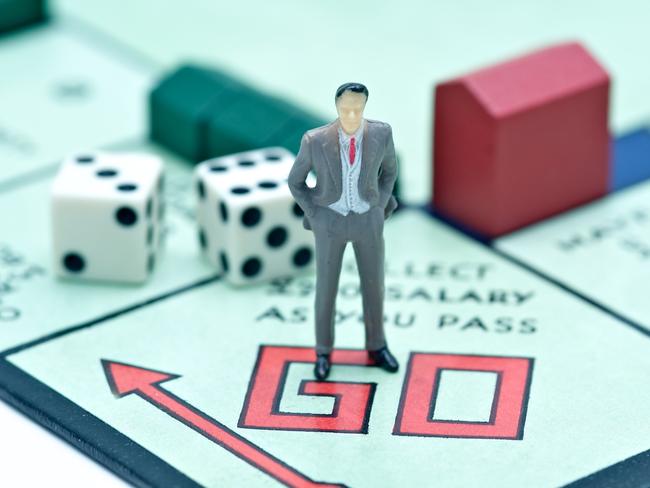 London, UK - July 2, 2011: Model figurine of a businessman at the starting point of the board game monopoly