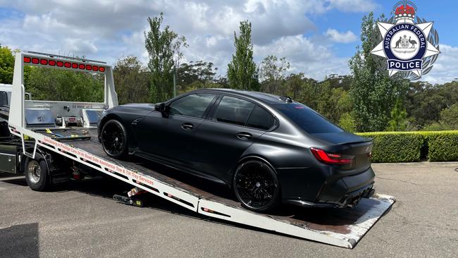 One of three BMWs being loaded onto a flat-bed truck. Picture: Australian Federal Police