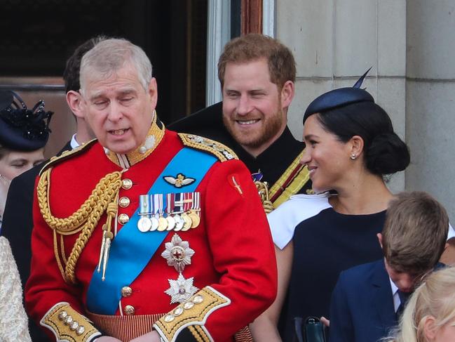 All smiles for now, but a lip reader claims Prince Harry was a little miffed that Meghan kept turning around to face him during Trooping The Colour. Picture: MATRIXPICTURES