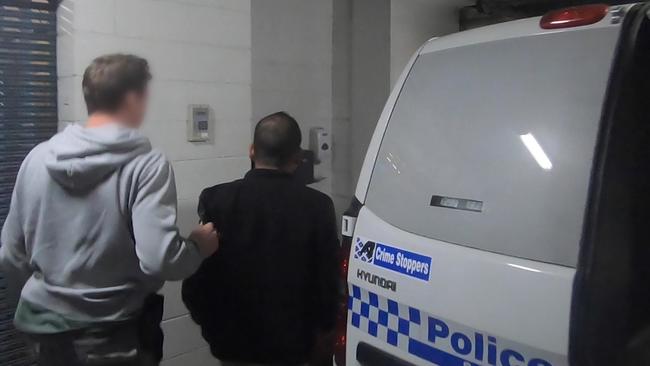 A man is taken to Merrylands police station. Picture: NSW Police Force