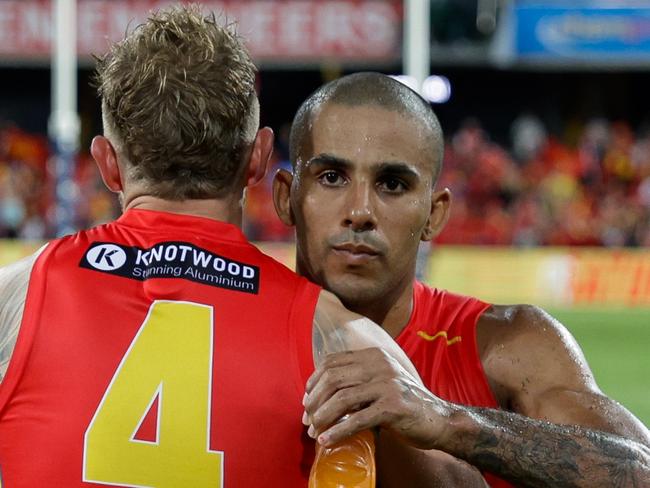 GOLD COAST, AUSTRALIA - MARCH 09: Touk Miller and Brandon Ellis of the Suns celebrate after the 2024 AFL Opening Round match between the Gold Coast SUNS and the Richmond Tigers at People First Stadium on March 09, 2024 in Gold Coast, Australia. (Photo by Russell Freeman/AFL Photos via Getty Images)