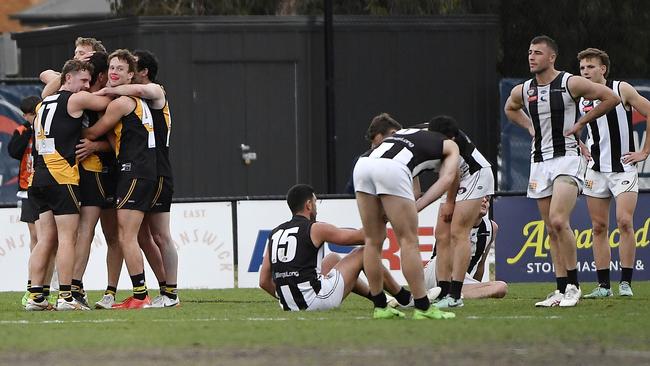 Heidelberg players celebrate, while Montmorency players commiserate. Picture: Andrew Batsch