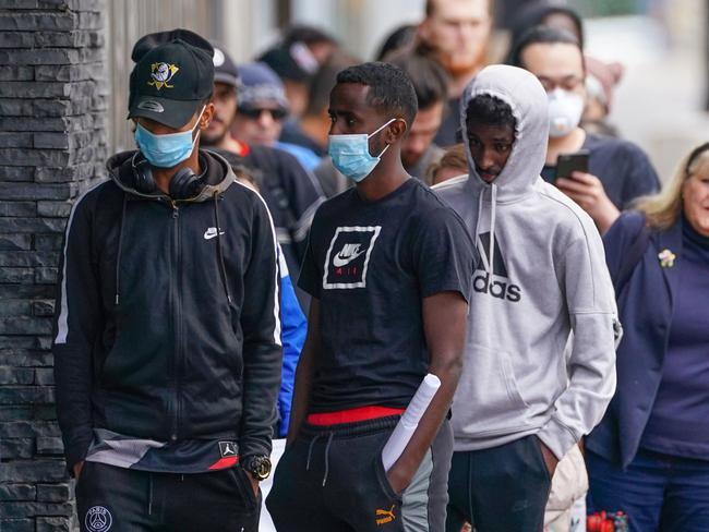 People are seen in long queue outside a Centrelink office in Melbourne’s Abbotsford. Picture: AAP