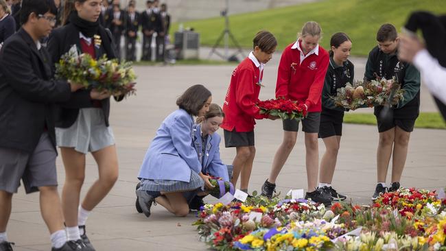 Students laid wreaths at the Eternal Flame during the ceremony.