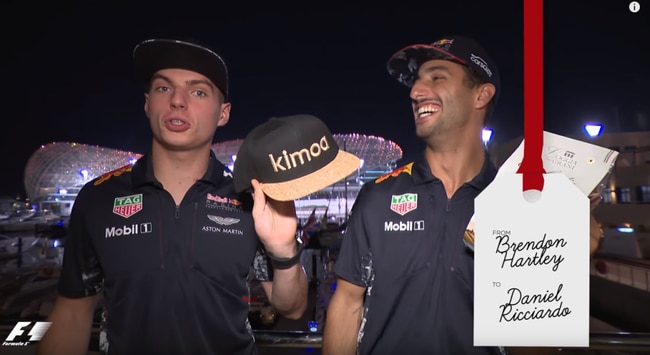 Max Verstappen and Dan Ricciardo laugh over their gifts.