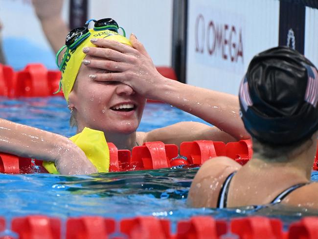 Australia's Ariarne Titmus (L) and USA's Kathleen Ledecky react after taking gold and silver respectively, in the final of the women's 400m freestyle swimming event during the Tokyo 2020 Olympic Games at the Tokyo Aquatics Centre in Tokyo on July 26, 2021. (Photo by Attila KISBENEDEK / AFP)