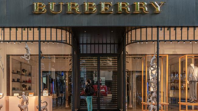 A woman looking inside a closed Burberry store in Melbourne. Picture: Asanka Ratnayake/Getty Images