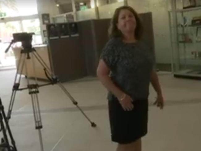 A staffer for Gold Coast Mayor Tom Tate tells an ABC news crew they're not welcome at today's press conference. Picture: ABC