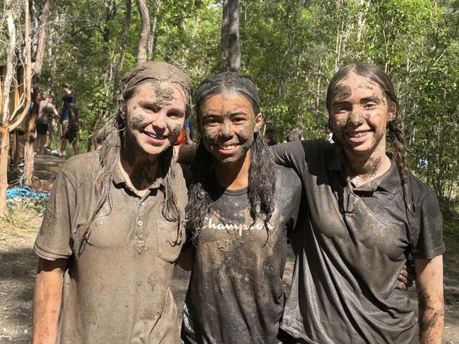 The girls enjoying the fun of the muddy obstacle course.