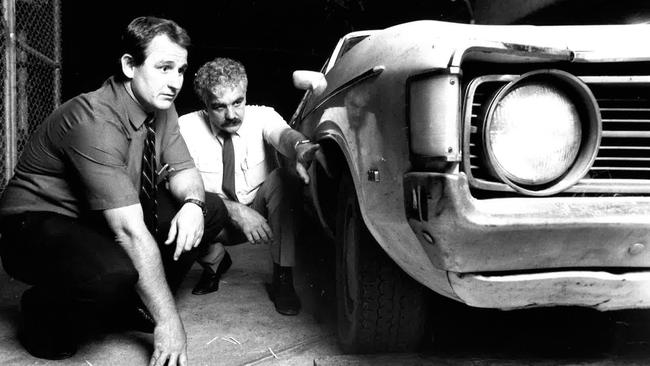 Queensland police detectives Peter McIlwain and Les Melville (not Barbaro’s police handler) inspect a car involved in the execution murder of Barbaro. Picture: Courier Mail