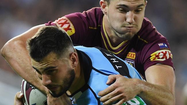 Jack Bird of the Blues is tackled by Corey Oates of Queensland.