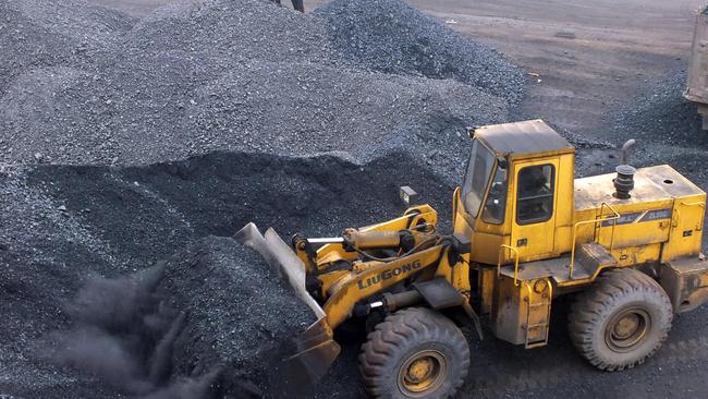 An excavator moves coal at a Chinese port. Picture: AFP