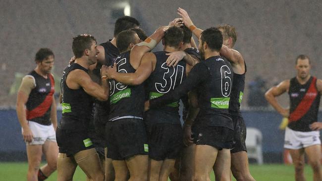 Carlton players rejoice after their upset win over Essendon. Picture: Wayne Ludbey