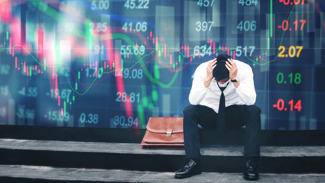 Tired or stressed businessman sitting on the walkway in panic digital stock market financial background