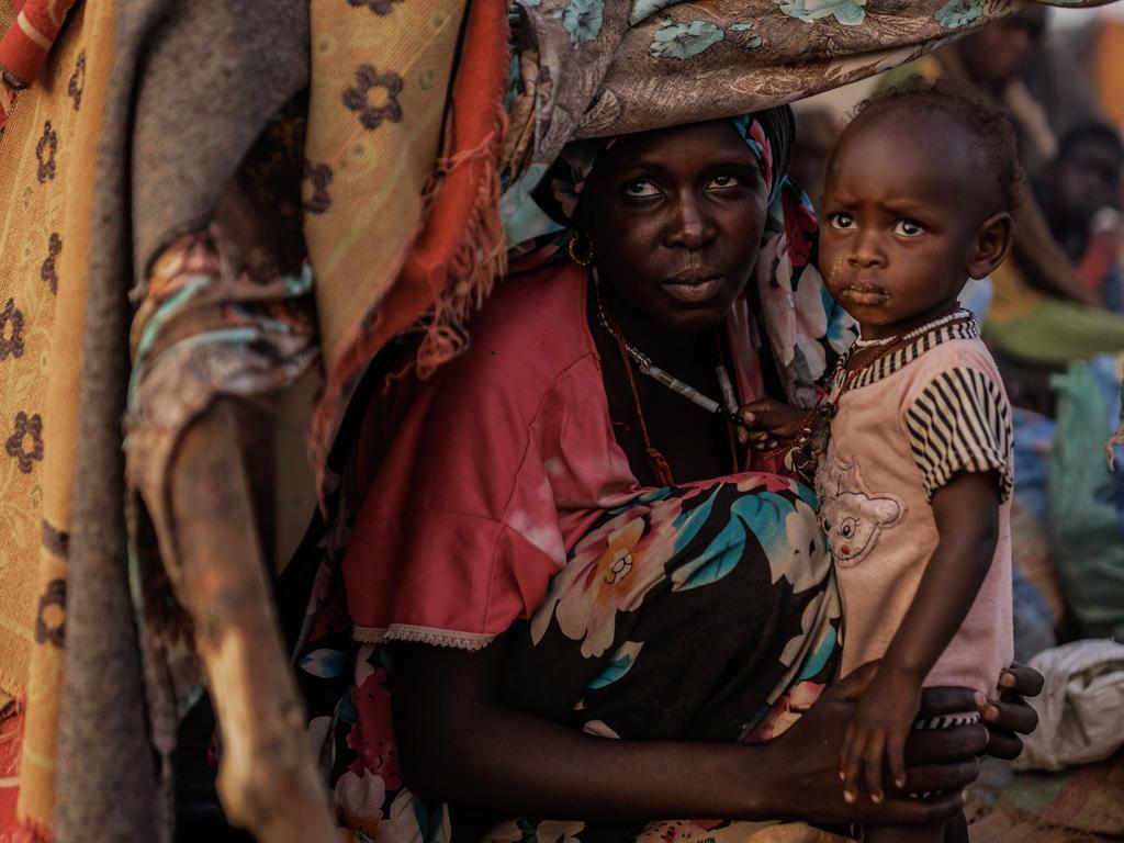 Zahra Tarreel Adam, 19, and her one-year-old son Abdallah, refugees from Kandobe, Darfur, shelter in a makeshift camp in Chad. Since March 2023, over 600,000 have fled to Chad due to conflicts between the RSF and SAF in Sudan. Aid agencies warn of halting critical services without urgent funding. Picture: Dan Kitwood/Getty Images