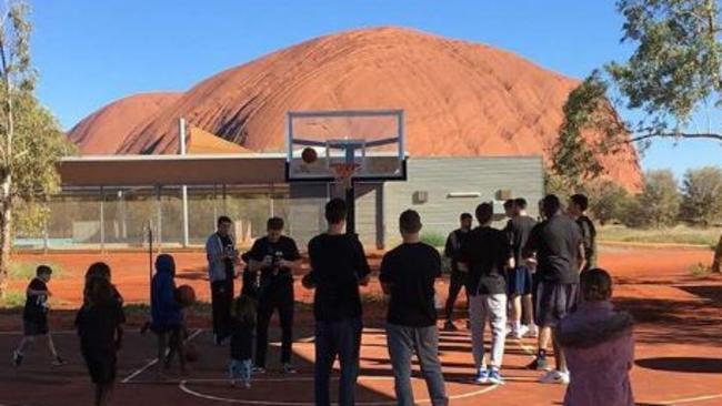 The Boomers and the refurbished court at Uluru . Picture: Adam Gibson