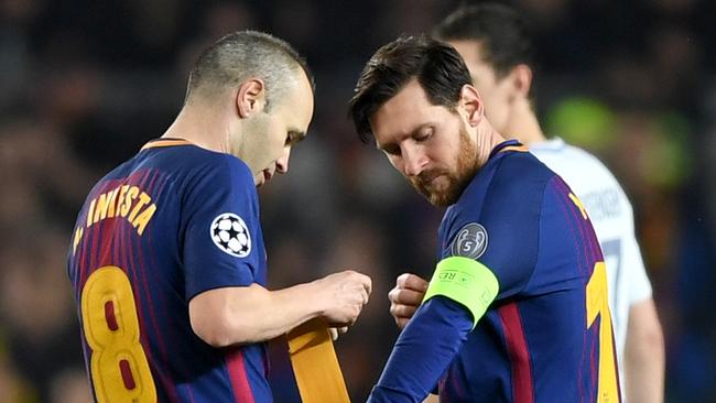 Andres Iniesta of Barcelona hands the captain's armband to Lionel Messi