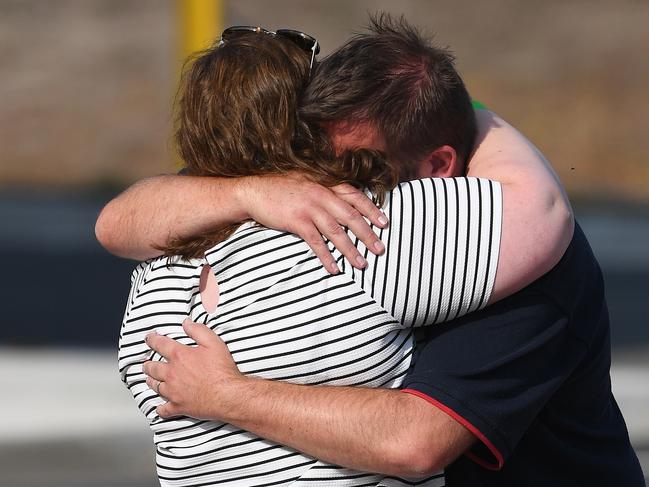 A Mallacoota bushfire evacuee is embarced at the Somerville Recreation Centre in Somerville south-east of Melbourne, Saturday, January 4, 2019. The group arrived at the port of Hastings on MV Sycamore this morning. (AAP Image/Julian Smith) NO ARCHIVING