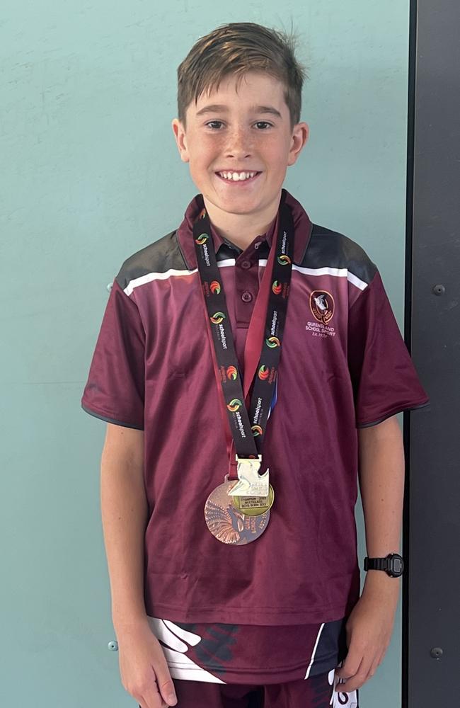 Our Lady of Lourdes student Odin Phillips with his cross country medals.