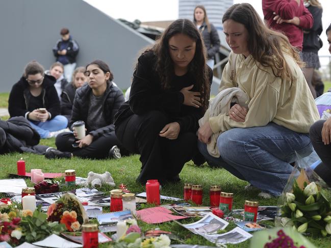 Munich: Mourning fans gather around a tree adorned with flowers, handwritten messages and photos near the Olympiahalle during a tribute event for One Direction singer Liam Payne. Picture: Getty Images