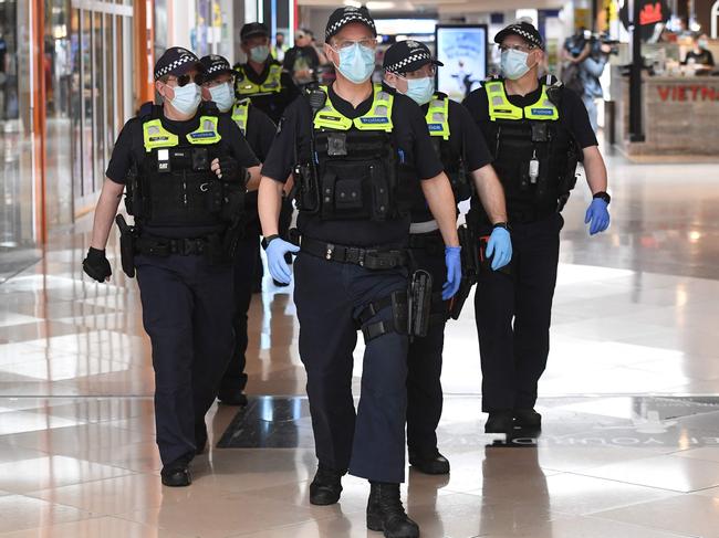 Police patrol through a shopping centre after an anti-lockdown protest in the Melbourne. Picture: AFP