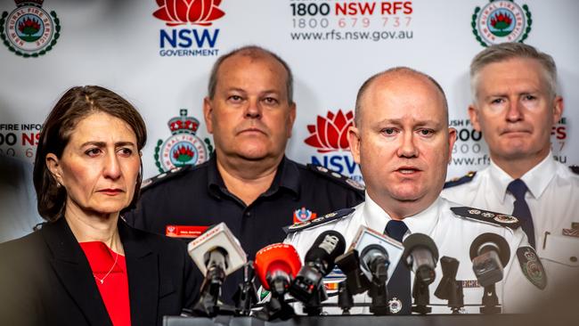 Premier Gladys Berejiklian and Police and Emergency Services Minister David Elliott listen as Commissioner Fitzsimmons briefs the media. Picture: Monique Harmer