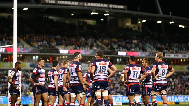 The Rebels gather behind the goal line after a Brumbies try at GIO Stadium.