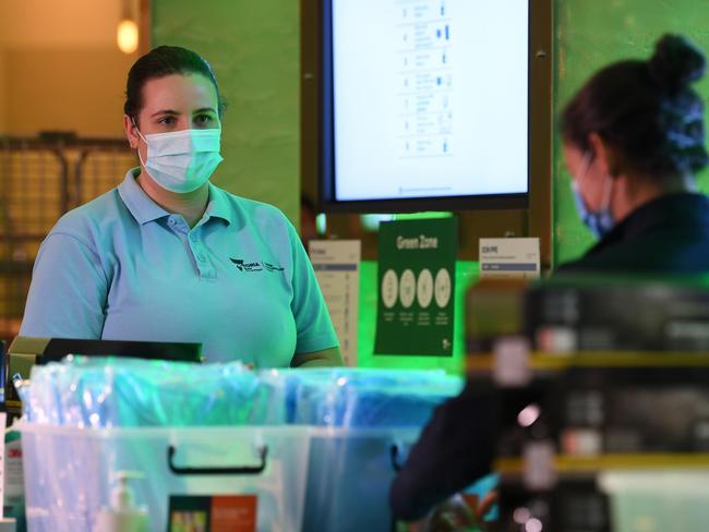 Healthcare workers are seen at a personal protective equipment station inside of the Grand Hyatt Melbourne in Melbourne, Tuesday, January 12, 2021. Three major hotels, the Grand Hyatt, Pullman Albert Park and the View on St Kilda Road in Melbourne have been refitted to make them appropriate to house Australian Open tennis players and staff. (AAP Image/James Ross) NO ARCHIVING