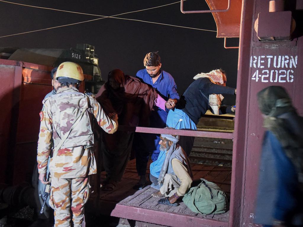 A soldier works to evacuate freed train passengers. Picture: AFP