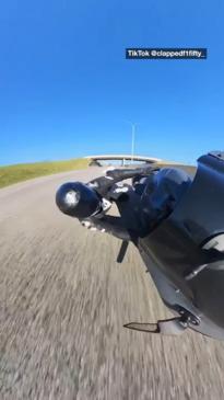 Biker has close call after falling on highway